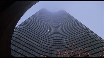 Movie still from “While You Were Sleeping” (1995), directed by Jon Turteltaub – Looking up at a very tall skyscraper in a city; Extreme Wide shot, Low angle