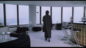 Movie still from “While You Were Sleeping” (1995), directed by Jon Turteltaub – A woman walking in front of a window in a room; Wide shot, High angle