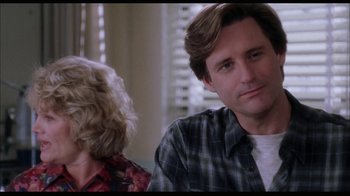 Movie still from “While You Were Sleeping” (1995), directed by Jon Turteltaub – A man and a woman sitting in front of each other; Close Up shot, Over the shoulder angle