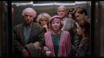 Movie still from “While You Were Sleeping” (1995), directed by Jon Turteltaub – A group of older people in a train car; Medium shot, High angle