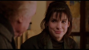 Movie still from “While You Were Sleeping” (1995), directed by Jon Turteltaub – A woman that is looking at a man; Close Up shot, Over the shoulder angle