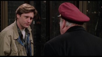 Movie still from “While You Were Sleeping” (1995), directed by Jon Turteltaub – A man and a man wearing a red hat; Medium shot, Over the shoulder angle