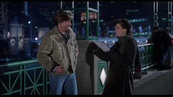 Movie still from “While You Were Sleeping” (1995), directed by Jon Turteltaub – A man and a woman are standing next to each other; Medium shot, Over the shoulder angle