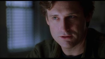 Movie still from “While You Were Sleeping” (1995), directed by Jon Turteltaub – A man's face in a dark room; Close Up shot, Over the shoulder angle
