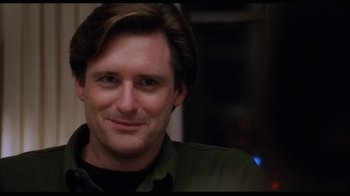 Movie still from “While You Were Sleeping” (1995), directed by Jon Turteltaub – A person smiling for the camera; Close Up shot, Over the shoulder angle