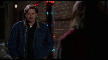 Movie still from “While You Were Sleeping” (1995), directed by Jon Turteltaub – A man standing in front of a brick wall; Medium shot, Over the shoulder angle
