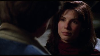 Movie still from “While You Were Sleeping” (1995), directed by Jon Turteltaub – A person looking at the camera; Close Up shot, Over the shoulder angle