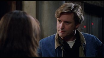 Movie still from “While You Were Sleeping” (1995), directed by Jon Turteltaub – A man in a blue jacket is talking to a woman in front of a mirror; Close Up shot, Over the shoulder angle