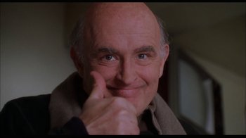 Movie still from “While You Were Sleeping” (1995), directed by Jon Turteltaub – An older man with a shaved head and a goatee is smiling; Close Up shot, Low angle