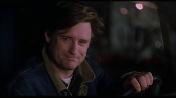 Movie still from “While You Were Sleeping” (1995), directed by Jon Turteltaub – A person sitting in front of a camera; Close Up shot, Over the shoulder angle
