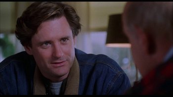 Movie still from “While You Were Sleeping” (1995), directed by Jon Turteltaub – A person sitting in a room; Close Up shot, Over the shoulder angle