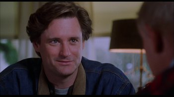 Movie still from “While You Were Sleeping” (1995), directed by Jon Turteltaub – A person sitting in a room; Close Up shot, Over the shoulder angle