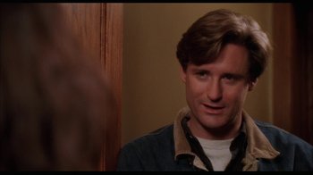 Movie still from “While You Were Sleeping” (1995), directed by Jon Turteltaub – A person wearing a jacket; Close Up shot, Over the shoulder angle