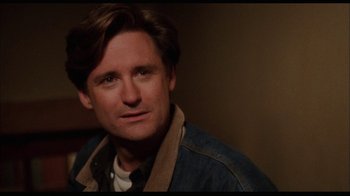 Movie still from “While You Were Sleeping” (1995), directed by Jon Turteltaub – A person wearing a jean jacket; Close Up shot, Over the shoulder angle