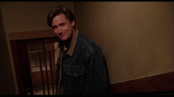 Movie still from “While You Were Sleeping” (1995), directed by Jon Turteltaub – A man standing in front of a wooden railing; Medium shot, Low angle