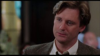 Movie still from “While You Were Sleeping” (1995), directed by Jon Turteltaub – A person wearing a suit and tie; Close Up shot, Over the shoulder angle