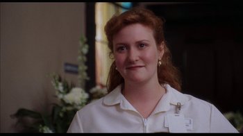 Movie still from “While You Were Sleeping” (1995), directed by Jon Turteltaub – A person wearing a white shirt; Close Up shot, Over the shoulder angle