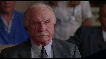 Movie still from “While You Were Sleeping” (1995), directed by Jon Turteltaub – An old man with a mustache wearing a suit and tie; Close Up shot, Low angle