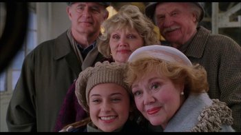 Movie still from “While You Were Sleeping” (1995), directed by Jon Turteltaub – A group of people posing for a picture together; Medium shot, High angle