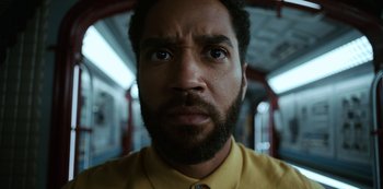 Movie still from “Another Life” (2019), created by Aaron Martin – A person wearing a yellow shirt; Close Up shot, Low angle