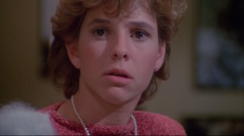 Movie still from “White Dog” (1982), directed by Samuel Fuller – A young woman with short blonde hair wearing a pink sweater; Close Up shot, Low angle