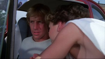 Movie still from “White Dog” (1982), directed by Samuel Fuller – A man and a woman sitting in a car; Close Up shot, Over the shoulder angle