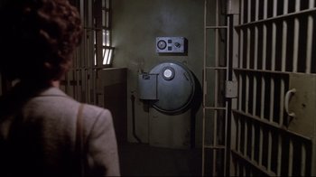 Movie still from “White Dog” (1982), directed by Samuel Fuller – A woman standing in front of a jail cell; Wide shot, High angle