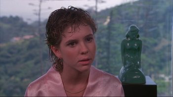 Movie still from “White Dog” (1982), directed by Samuel Fuller – A woman in a pink robe looks to her left; Close Up shot, Over the shoulder angle