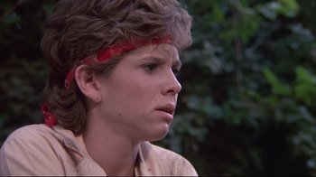 Movie still from “White Dog” (1982), directed by Samuel Fuller – A woman with a red headband is looking to the side; Close Up shot, Low angle