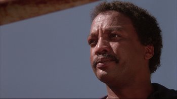 Movie still from “White Dog” (1982), directed by Samuel Fuller – A person with a mustache; Close Up shot, Low angle