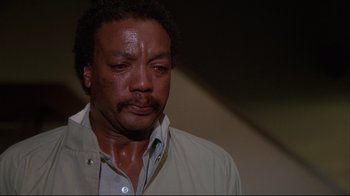 Movie still from “White Dog” (1982), directed by Samuel Fuller – A person with his eyes closed; Close Up shot, Low angle