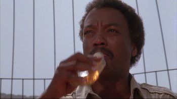 Movie still from “White Dog” (1982), directed by Samuel Fuller – A person eating a sandwich; Close Up shot, Low angle