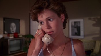 Movie still from “White Dog” (1982), directed by Samuel Fuller – A woman holding a phone up to her ear; Close Up shot, High angle