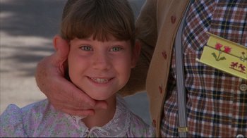 Movie still from “White Dog” (1982), directed by Samuel Fuller – A person holding a child's neck; Close Up shot, Low angle