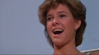 Movie still from “White Dog” (1982), directed by Samuel Fuller – A person smiling with her mouth wide open; Close Up shot, Low angle