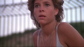 Movie still from “White Dog” (1982), directed by Samuel Fuller – A person wearing a white tank top; Close Up shot, Low angle