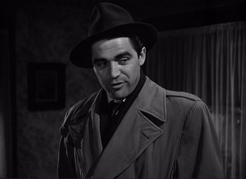 Movie still from “White Heat” (1949), directed by Raoul Walsh – A black and white photo of a man wearing a hat; Close Up shot, Low angle