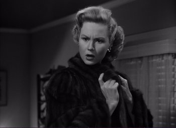 Movie still from “White Heat” (1949), directed by Raoul Walsh – A black and white photo of a woman in a fur coat; Close Up shot, Low angle