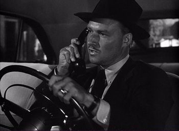 Movie still from “White Heat” (1949), directed by Raoul Walsh – A black and white photo of a man talking on a phone; Close Up shot, Low angle