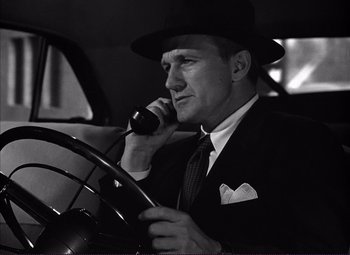 Movie still from “White Heat” (1949), directed by Raoul Walsh – A black and white photo of a man talking on a phone; Close Up shot, Low angle