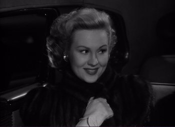 Movie still from “White Heat” (1949), directed by Raoul Walsh – A black and white photo of a woman in a car; Close Up shot, Over the shoulder angle