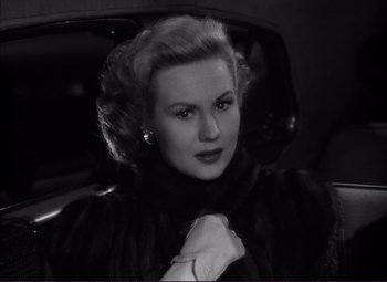 Movie still from “White Heat” (1949), directed by Raoul Walsh – A black and white photo of a woman in a car; Close Up shot, High angle