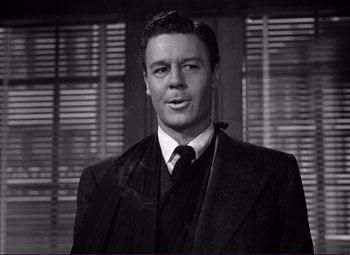 Movie still from “White Heat” (1949), directed by Raoul Walsh – Black and white photograph of a man wearing a suit and tie; Close Up shot, Low angle