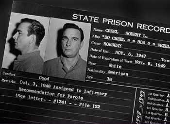 Movie still from “White Heat” (1949), directed by Raoul Walsh – A black and white photo of an inmate's prison record; Close Up shot, High angle