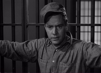 Movie still from “White Heat” (1949), directed by Raoul Walsh – A black and white photo of a man in a prison cell; Close Up shot, Low angle