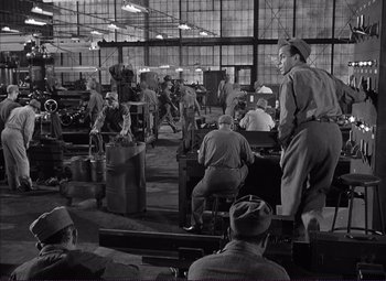 Movie still from “White Heat” (1949), directed by Raoul Walsh – A black and white photo of men in a factory; Wide shot, High angle