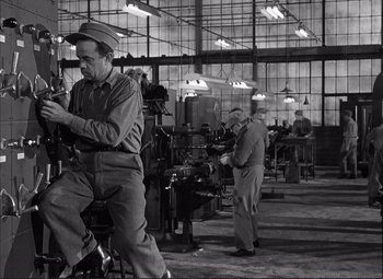 Movie still from “White Heat” (1949), directed by Raoul Walsh – A group of men working in an industrial setting; Wide shot, High angle