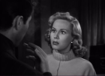 Movie still from “White Heat” (1949), directed by Raoul Walsh – An old black and white photo of a man and a woman talking; Close Up shot, Over the shoulder angle