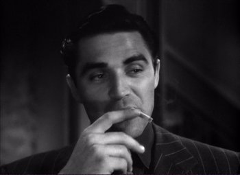 Movie still from “White Heat” (1949), directed by Raoul Walsh – A black and white photo of a man smoking a cigarette; Close Up shot, Low angle