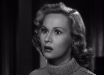 Movie still from “White Heat” (1949), directed by Raoul Walsh – A black and white photo of a woman looking at the camera; Close Up shot, Over the shoulder angle